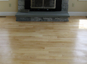Refinished hardwood floors by fireplace